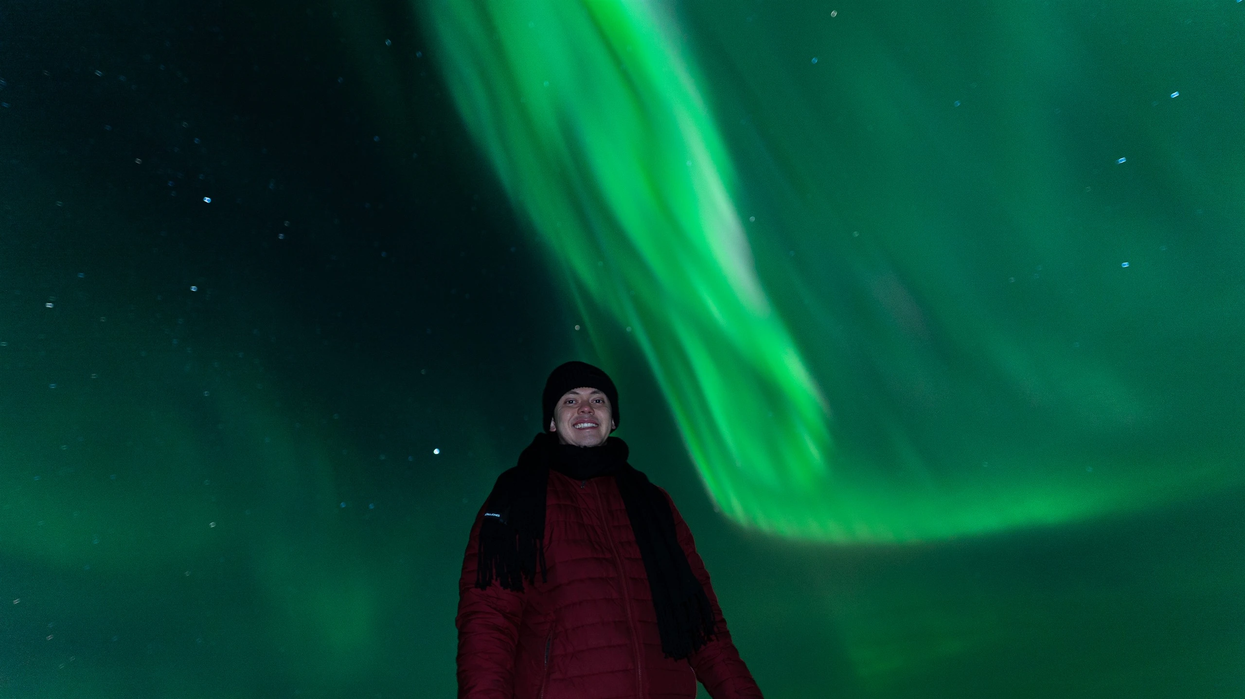 Aurora corona directly overhead a guest on a northern lights tour
