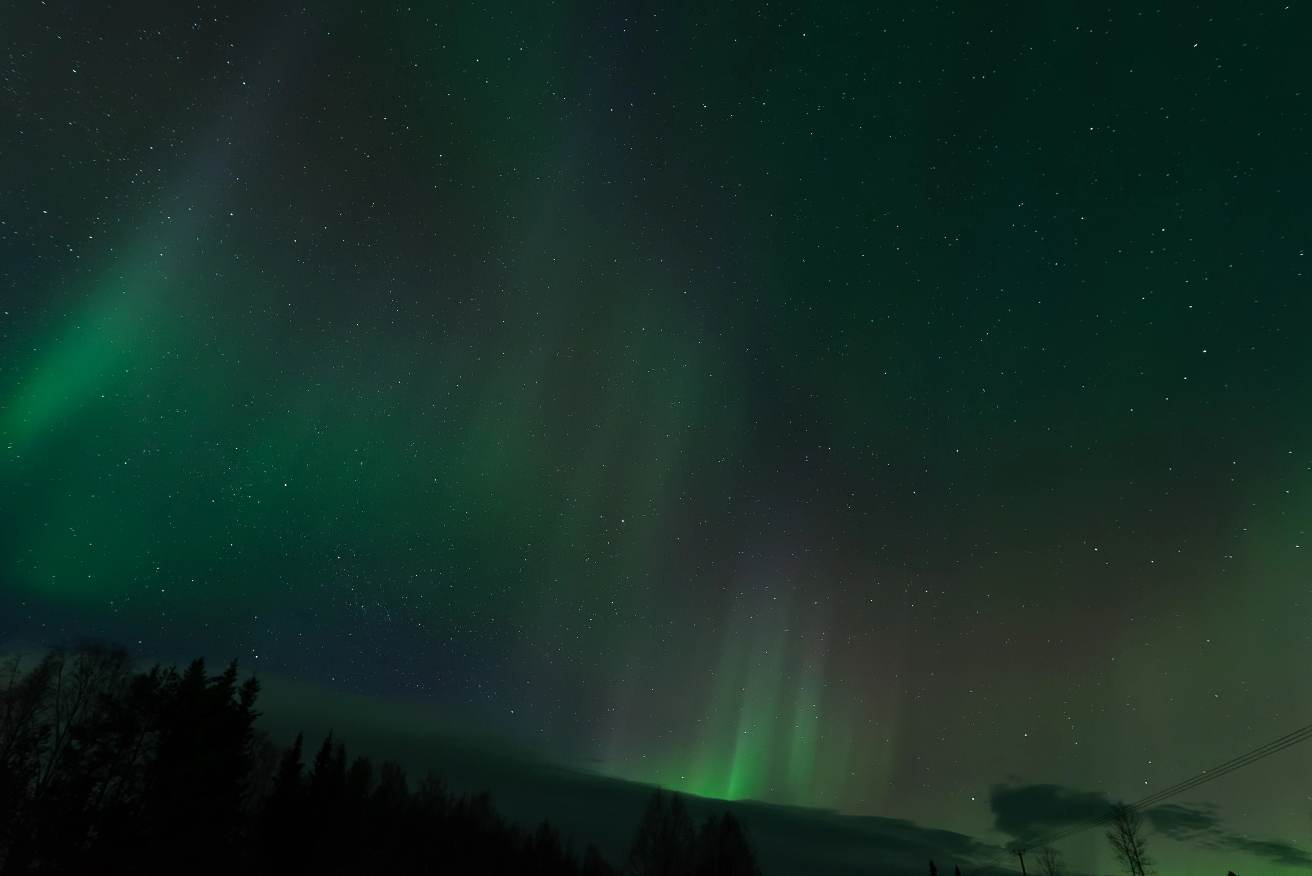 Aurora pillars rising over the night landscape in Finnish Lapland